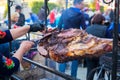 ÃÂ¡utting of delicious pork ham cooked on the skewer on open fire at a food fair. Royalty Free Stock Photo